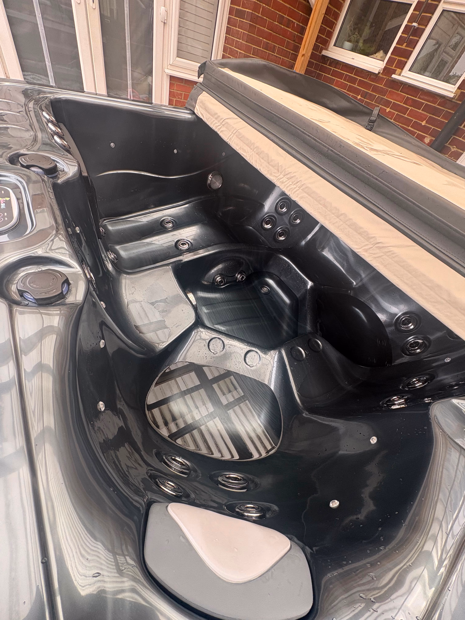 Detailed clean of a black hot tub