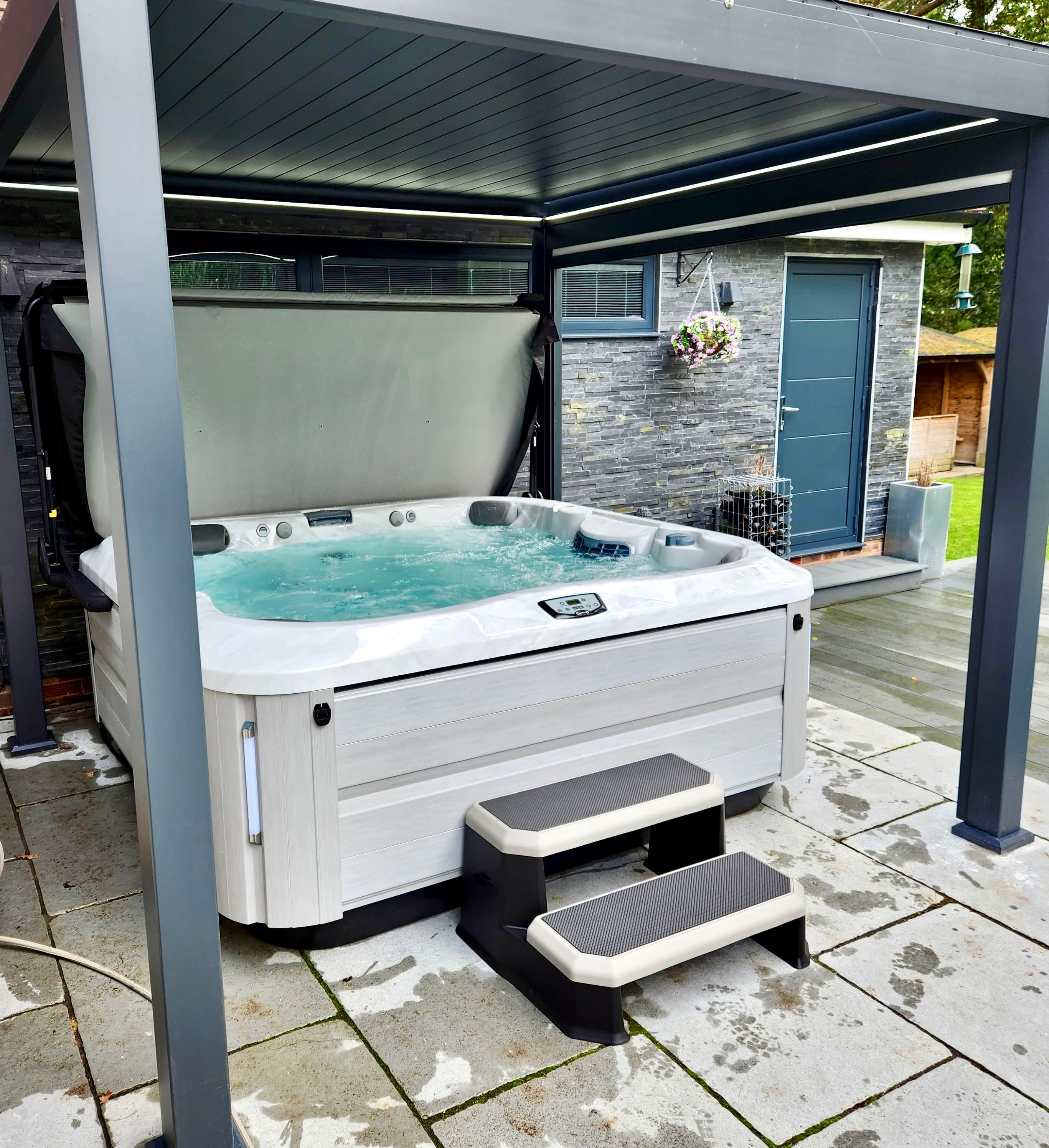 Hot tub maintained beneath a garden pergola