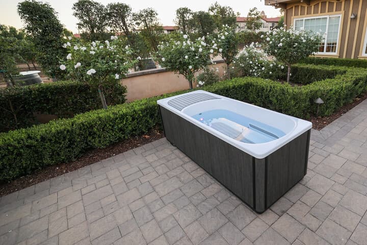 Outdoor cold plunge ice bath in a landscaped garden
